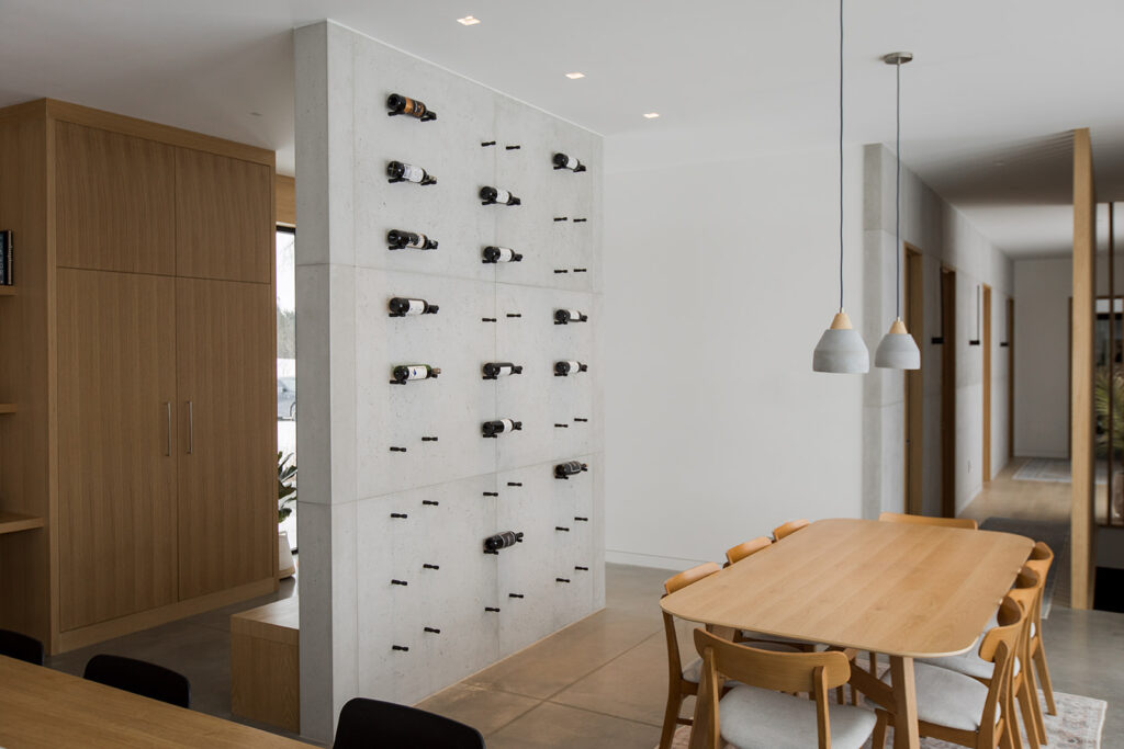 Modern featured wine rack built against a concrete wall. 