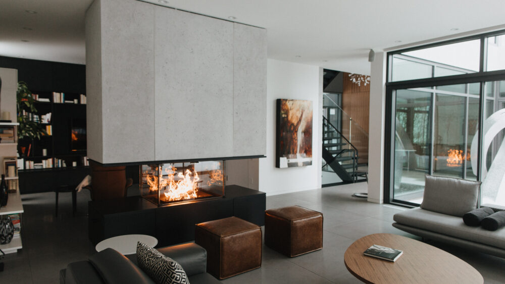 Modern living space with indoor fireplace and concrete cladding features.